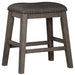 Caitbrook - Gray - Upholstered Stool Cleveland Home Outlet (OH) - Furniture Store in Middleburg Heights Serving Cleveland, Strongsville, and Online