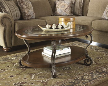 Nestor - Medium Brown - Oval Cocktail Table Cleveland Home Outlet (OH) - Furniture Store in Middleburg Heights Serving Cleveland, Strongsville, and Online