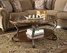Nestor - Medium Brown - Oval Cocktail Table Cleveland Home Outlet (OH) - Furniture Store in Middleburg Heights Serving Cleveland, Strongsville, and Online