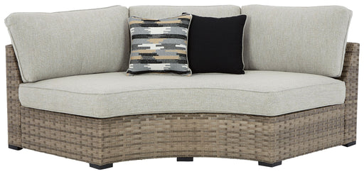 Calworth - Beige - Curved Loveseat With Cushion Cleveland Home Outlet (OH) - Furniture Store in Middleburg Heights Serving Cleveland, Strongsville, and Online